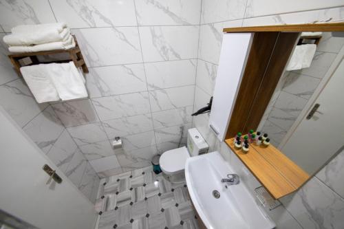 a bathroom with a toilet, sink, and bathtub at ROYAL TAKSIM SUITES in Istanbul