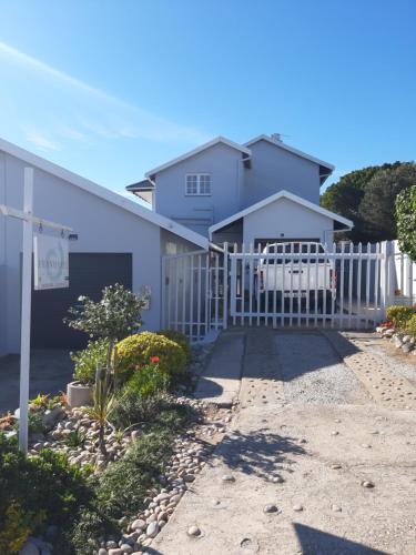 a white fence in front of a house at Franmarel in Plettenberg Bay