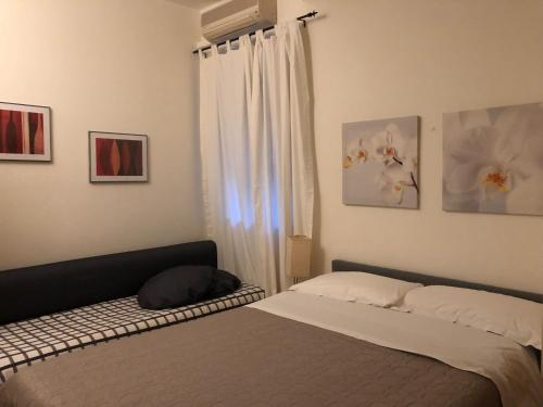a bedroom with a bed and a window at B&B Casale Coreallo Spotorno in Spotorno