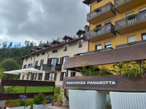 a hotel with a sign in front of a building at Residenza Panarotta - Vetriolo(1500m) in Levico Terme