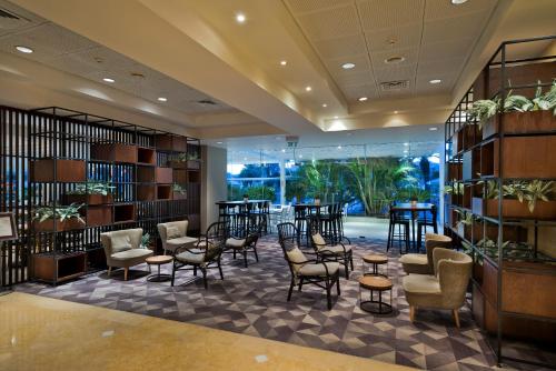 a library with chairs and tables and bookshelves at Lagoona by Isrotel Collection in Eilat
