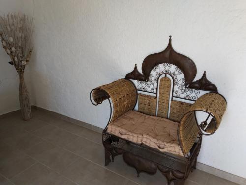 a chair sitting in a room next to a wall at U Palmu in Sagone