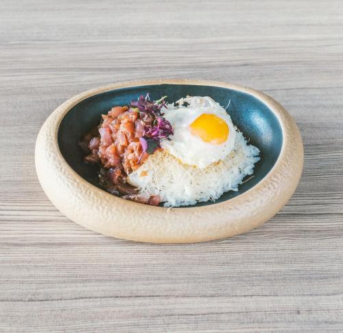 a bowl of rice with an egg on top at Novotel Barcelona Cornellà in Cornellà de Llobregat