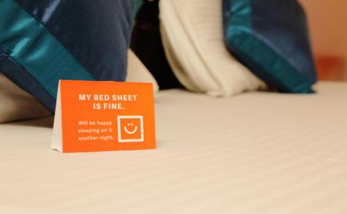 a sign sitting on top of a bed at Hotel Raj Kothi Jaipur airport in Jaipur