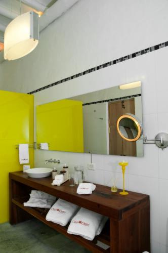 a bathroom with a sink and a mirror at Casa Oniri Hotel Boutique in Barichara