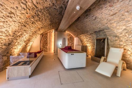a living room with a stone wall at Hotel Althof Retz in Retz
