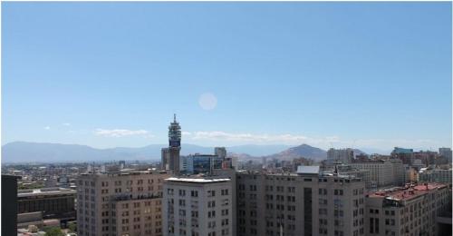 a view of a city with buildings and a tower at Zenteno Apartments in Santiago