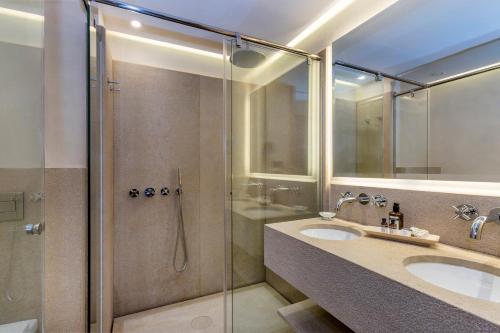 
a bathroom with a shower, sink, and tub at Es Moli in Deia
