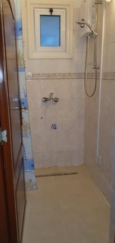 a bathroom with a shower with a glass door at Suluca Homes in Kérynia