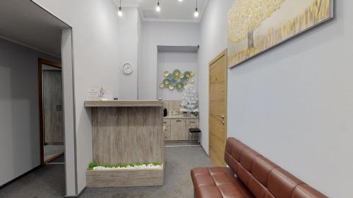 an office lobby with a reception desk and a couch at Grand Apartments in Kyiv