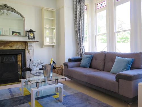 a living room with a couch and a fireplace at Broad Park Villa in Ilfracombe