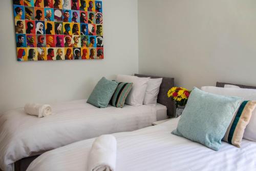two beds sitting next to each other in a room at Broadpark Villa in Ilfracombe