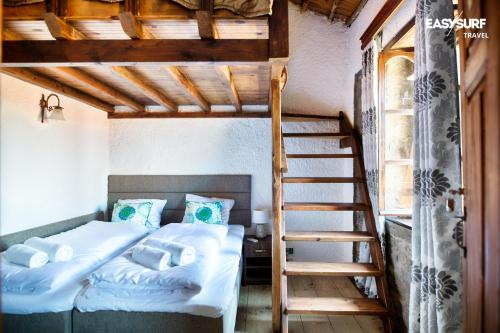 a bedroom with a bunk bed and a ladder at Stone House Limnos in Repanídhion
