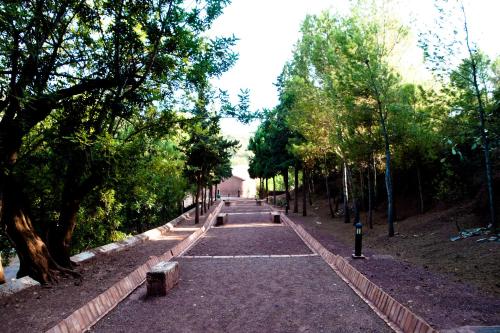 an empty path in a park with trees at Jardines de La Santa in Totana