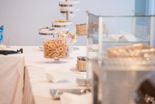 a table with plates of food in a room at Hotel San Francesco in Rende