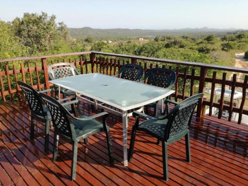 a table and chairs sitting on a deck at Dune View Cottage in Sodwana Bay
