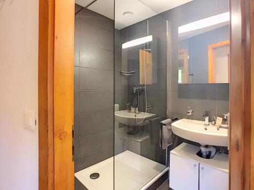 a bathroom with a sink and a mirror at Le Clavan - Studio à Crans-Montana (2-4 personnes) in Crans-Montana
