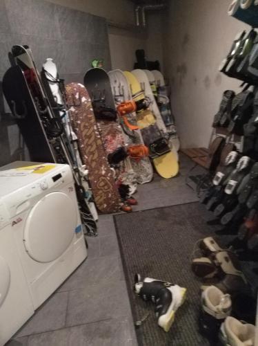 a room with a pile of snowboards and a washing machine at Haus Julia in Mühlbach am Hochkönig