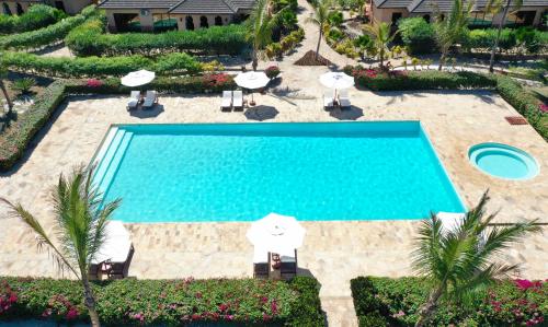 an overhead view of a swimming pool with umbrellas at The Sands Beach Resort in Bwejuu
