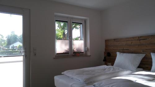 a bedroom with a bed and a window at Brigel-Hof in Meßkirch