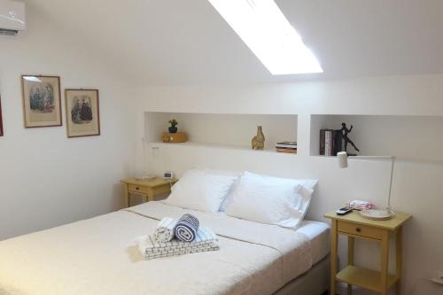 a bedroom with a white bed with two tables at Modern Cosy Flat with Terrace in Campo de Ourique. in Lisbon