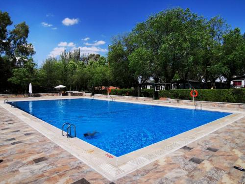 une grande piscine d'eau bleue dans l'établissement Bungalows Alpha, à Getafe