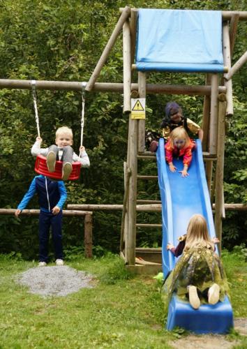 two children playing on a slide at a playground at Penzion a restaurace Na Hvězdě in Malá Morávka
