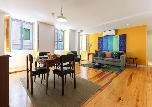 a dining room and living room with a table and chairs at ALTIDO Avenida Apartments in Lisbon