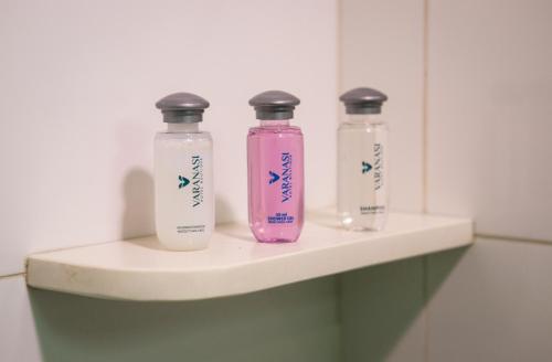 a couple of bottles sitting on a shelf in a bathroom at Varanasi Hotel Boutique Aeropuerto in Cartagena de Indias