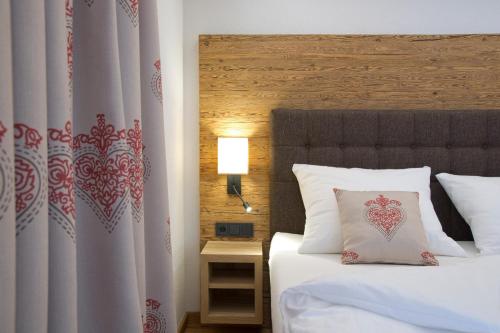 a hotel room with a bed with a pillow on it at Blattlhof in Sankt Johann in Tirol
