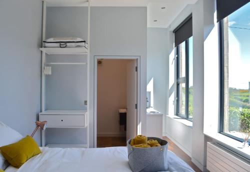 a bedroom with a bed with a bowl of fruit on it at School house Portaferry in Portaferry