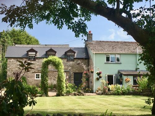an exterior view of a house with a garden at Brecon Boutique Breaks Wild Land in Sennybridge