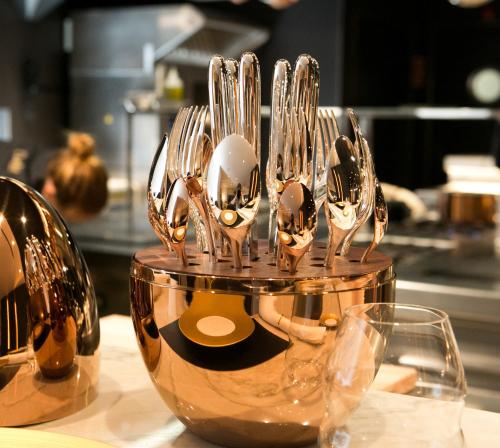 a group of silver spoons in a bowl on a counter at Ohla Barcelona in Barcelona