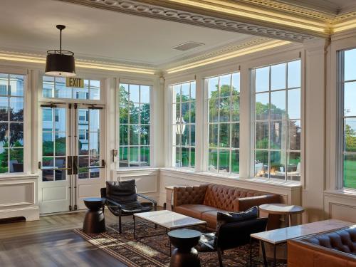 a living room with a couch and chairs and windows at Seaview, A Dolce Hotel in Galloway