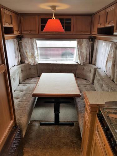 a small table in the back of an rv at Przyczepy Kemping Polaris Półwysep Helski in Chałupy