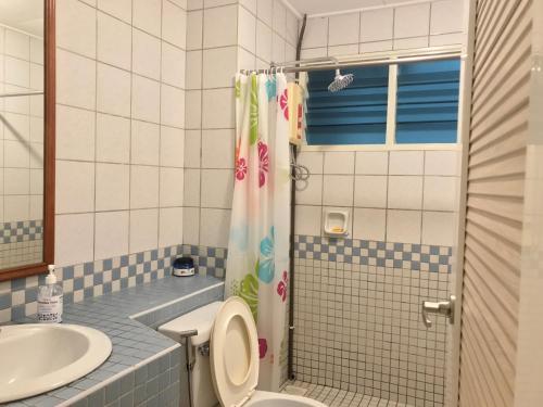 a bathroom with a toilet and a sink and a shower at Comfy Beachfront View at Seri Bulan Condominium Teluk Kemang Beach in Port Dickson