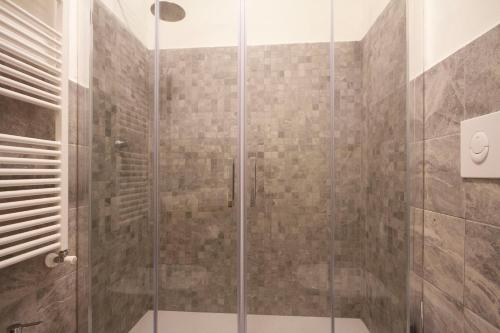 a shower with a glass door in a bathroom at B&B Poggiobonizio in Poggibonsi