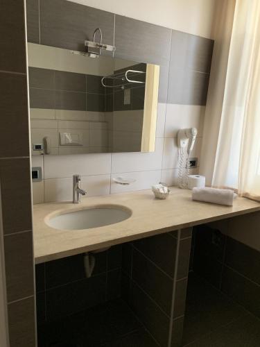 a bathroom with a sink and a mirror at Hotel Palace Gioia Tauro in Gioia Tauro