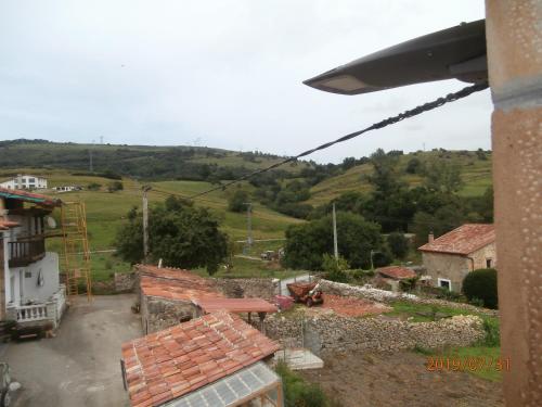 a view of a village with a hill in the background at Apartamento 2 Bielva in Bielva