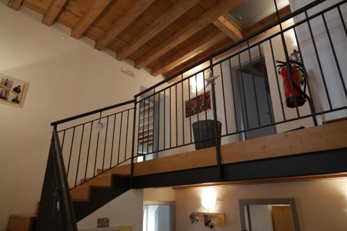a staircase in a house with a metal railing at Ostello Sociale Borgo Venno in Lavenone