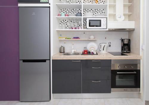 eine Küche mit Kühlschrank und Spüle in der Unterkunft Boas-Vindas in Albufeira
