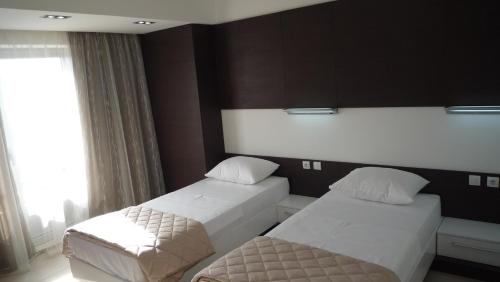 a bedroom with two beds and a window at Apartments Good Night in Niš