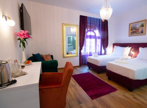 a hotel room with two beds and a desk at Center Luxury Rooms 3 in Split