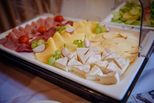 a plate of cheese and other foods on a table at Turciansky dvor in Martin