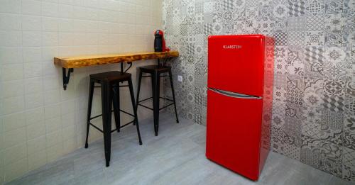 a red refrigerator in a room with a bar at Casa Rural Las Colmenas in Alcalá del Júcar