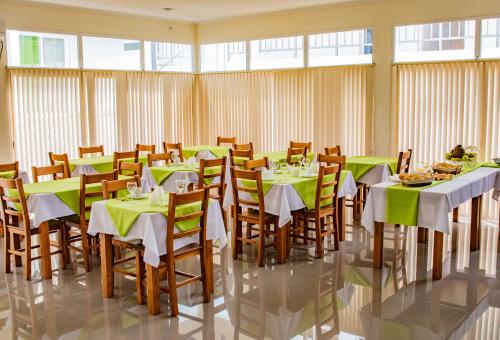a conference room with tables and chairs with food on them at Hotel Vitoria in São Tomé