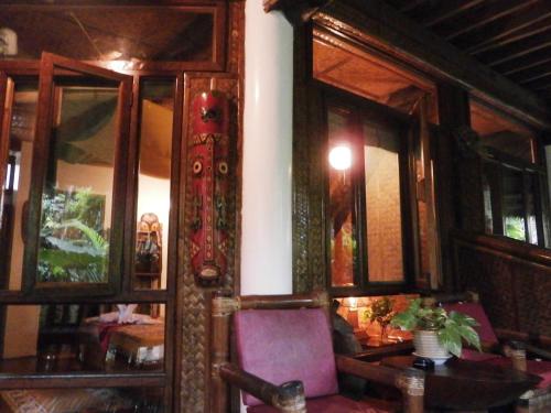 a room with a wooden door and a purple chair at Nigi Nigi Nu Noos 'e' Nu Nu Noos in Boracay