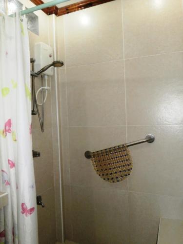 a bathroom with a shower with a shower curtain at Nigi Nigi Nu Noos 'e' Nu Nu Noos in Boracay