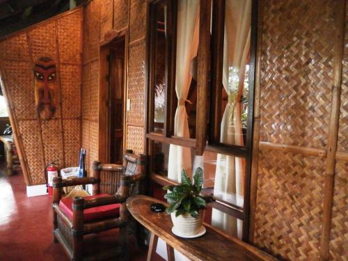 a room with a table with a potted plant on it at Nigi Nigi Nu Noos 'e' Nu Nu Noos in Boracay