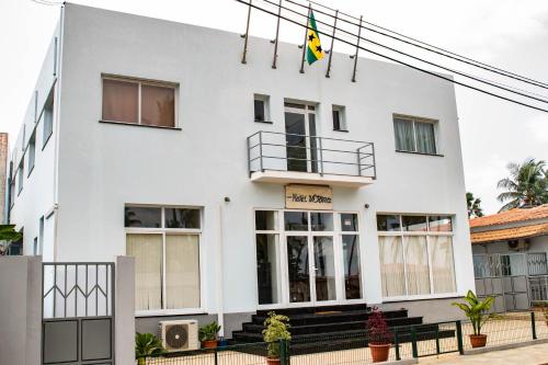 a white building with a sign on it at Hotel Vitoria in São Tomé